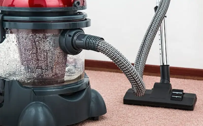Professional carpet cleaning — hot water extraction machine in use
